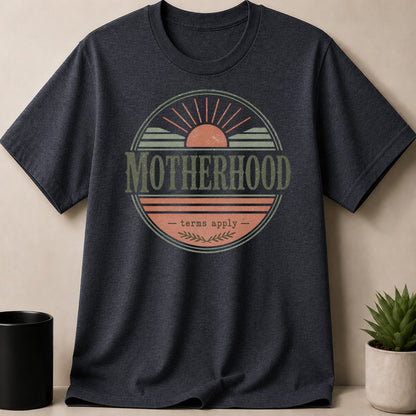 Dark gray t-shirt with a circular distressed graphic that reads "MOTHERHOOD - terms apply -"