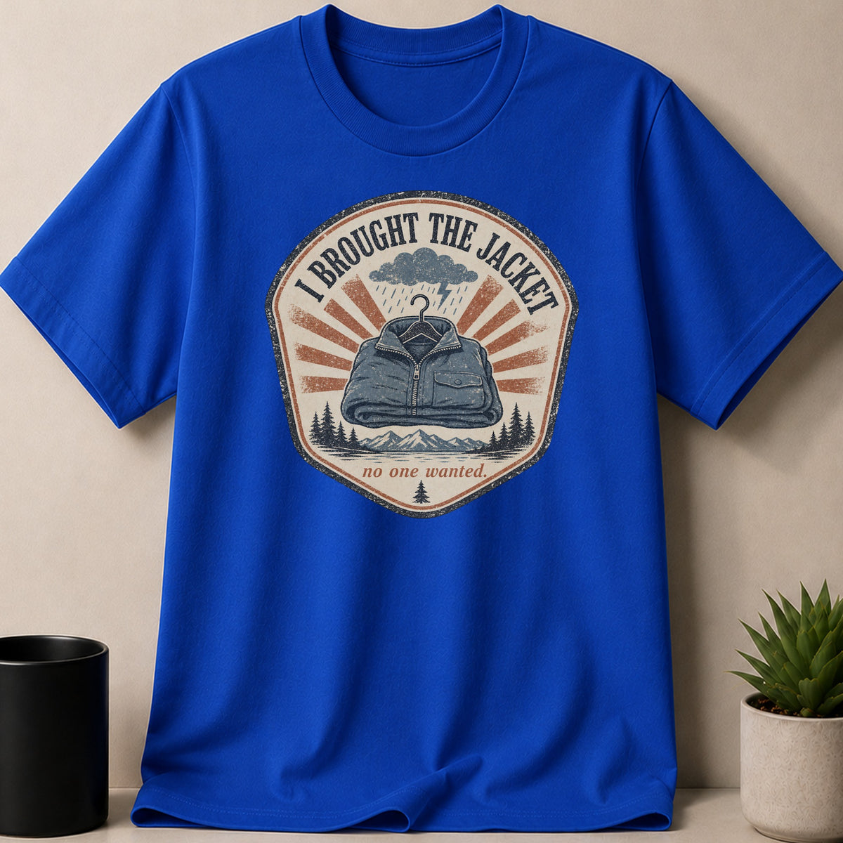 Blue t-shirt with "I BROUGHT THE JACKET no one wanted" graphic design.