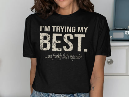 Black t-shirt with "I'M TRYING MY BEST. ...and frankly that's impressive." text.