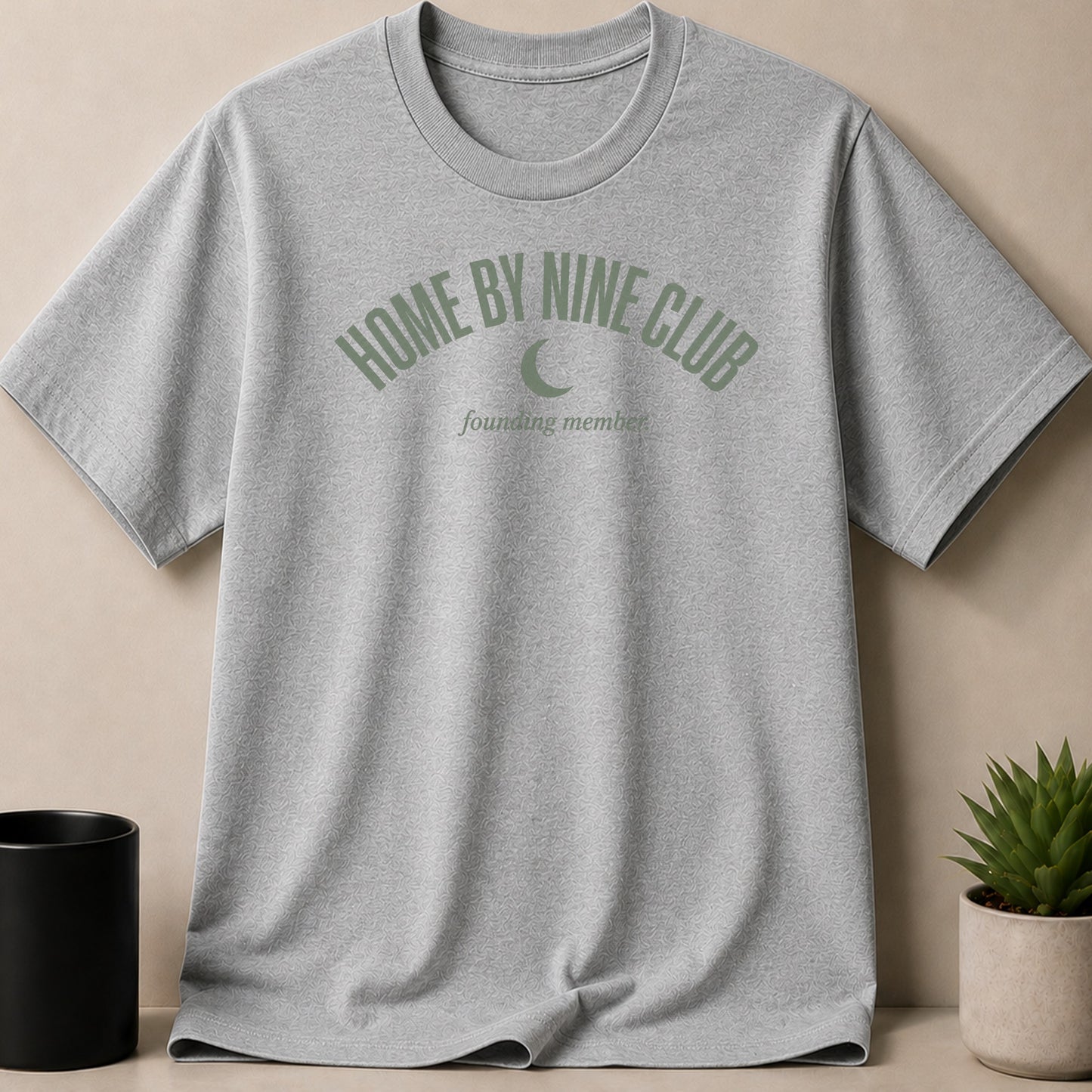 Grey t-shirt with green "HOME BY NINE CLUB" and crescent moon logo.