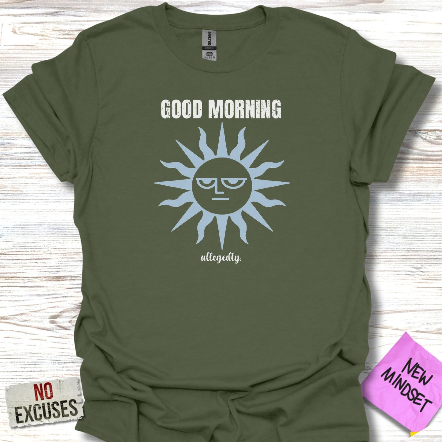 Green t-shirt with a sun graphic and the text "GOOD MORNING allegedly."