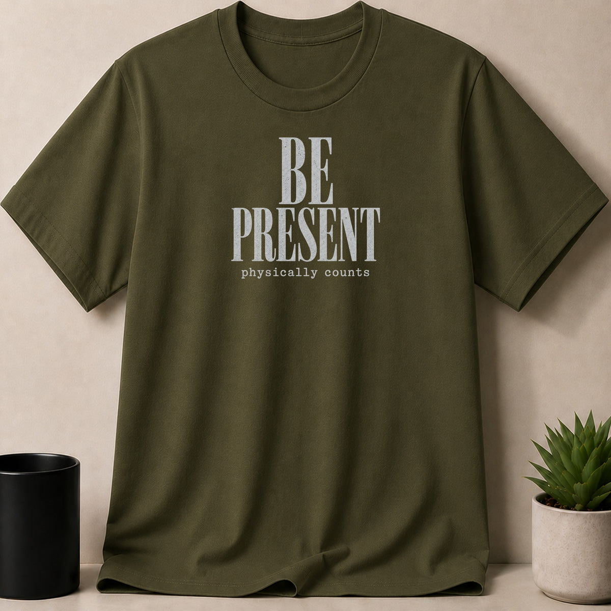 Olive green t-shirt with "BE PRESENT physically counts" text graphic.