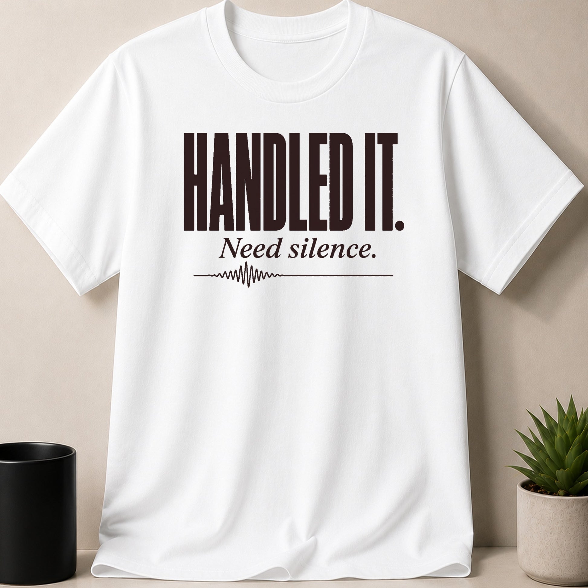 White t-shirt with dark text: "HANDLED IT. Need silence." and a waveform.