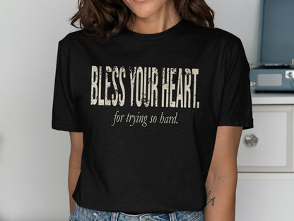 Black t-shirt with distressed text reading "BLESS YOUR HEART. for trying so hard."
