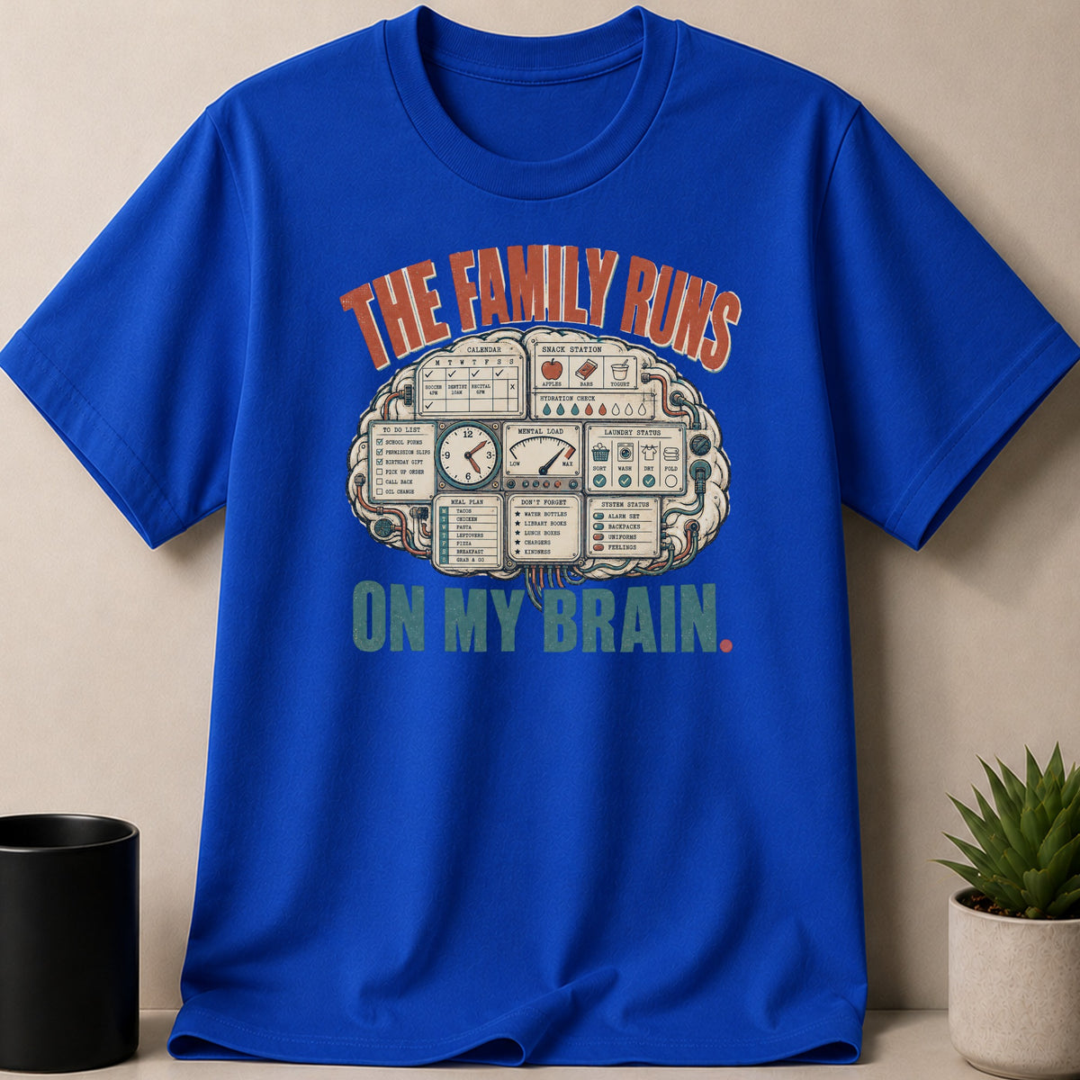 Blue t-shirt with graphic "The family runs on my brain" including brain diagram.