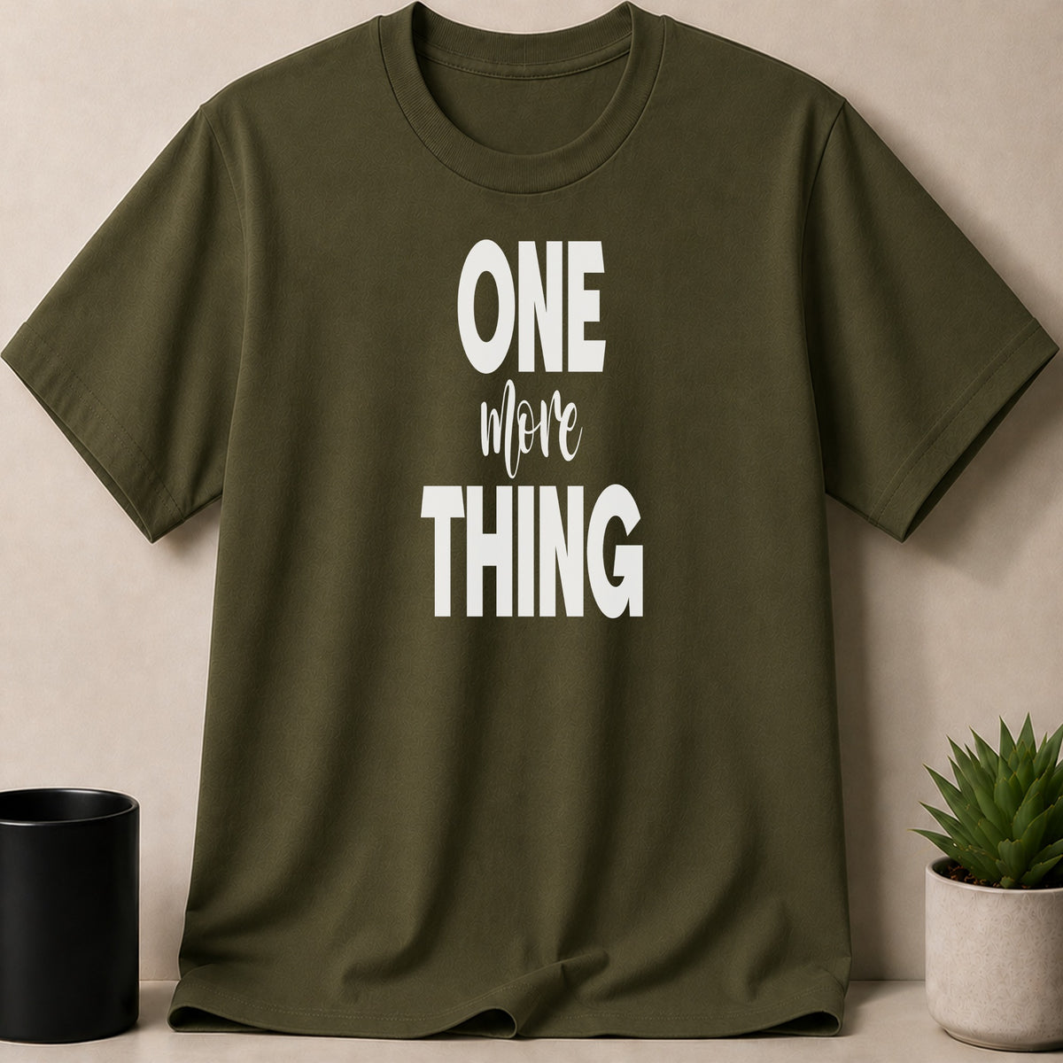 Olive green t-shirt with white text "ONE more THING"