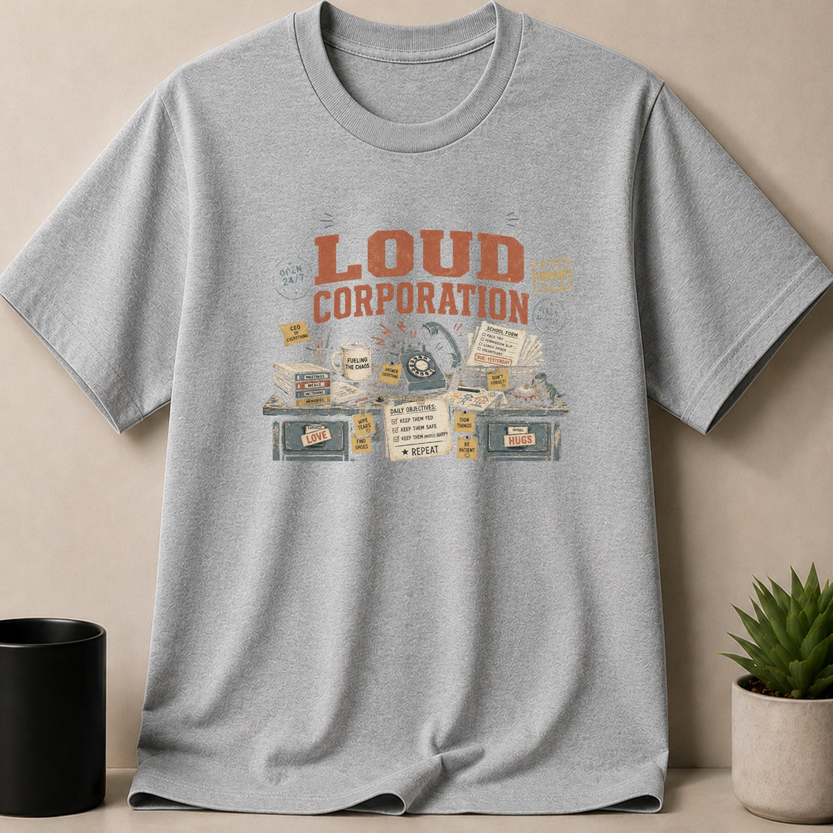Gray t-shirt with "Loud Corporation" graphic featuring vintage office items.