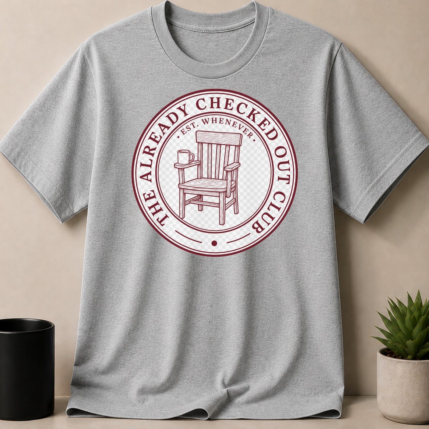 Grey t-shirt with a circular distressed graphic of a chair and mug.
