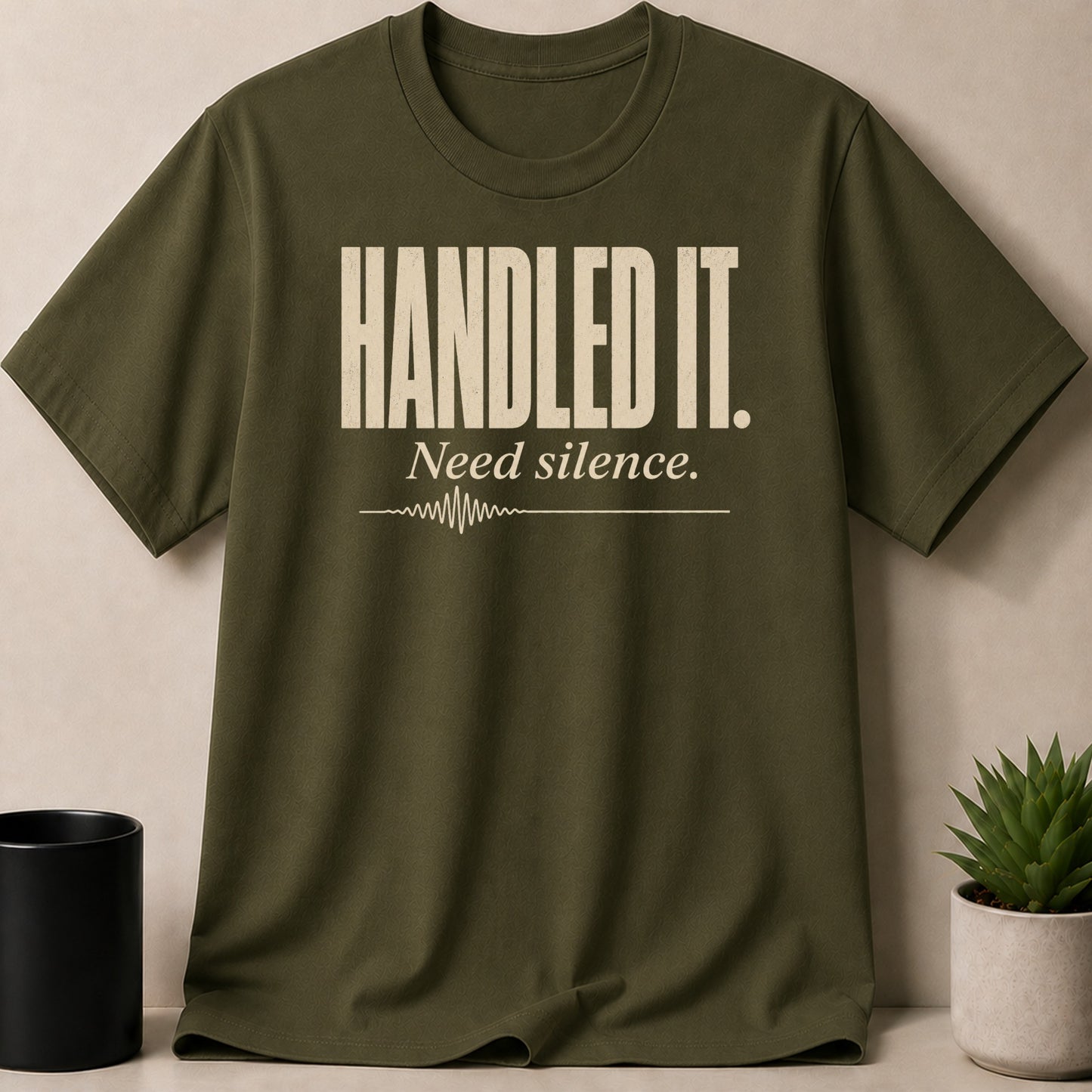 Olive t-shirt with "HANDLED IT. Need silence." text and sound wave graphic.