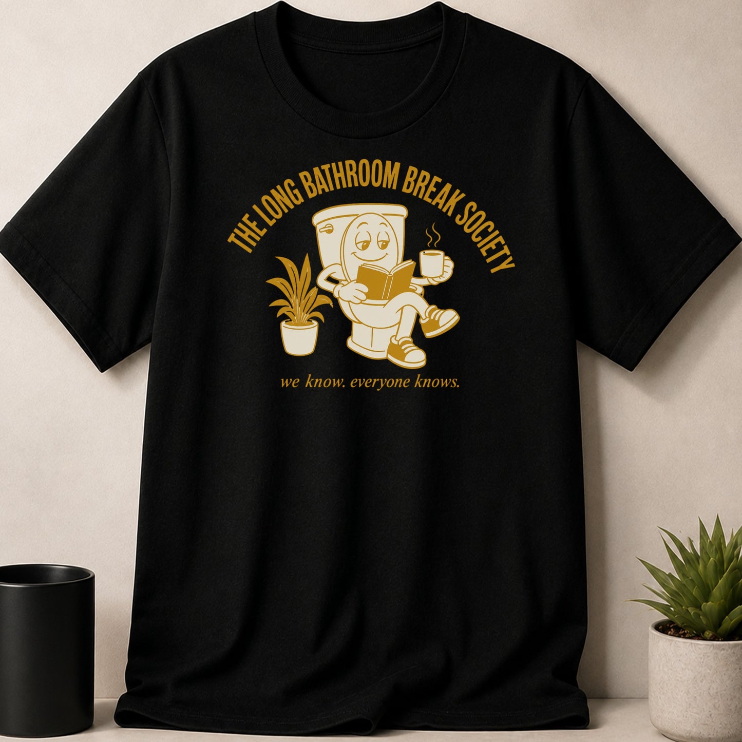 Black t-shirt with cartoon toilet reading and drinking coffee, "The Long Bathroom Break Society."