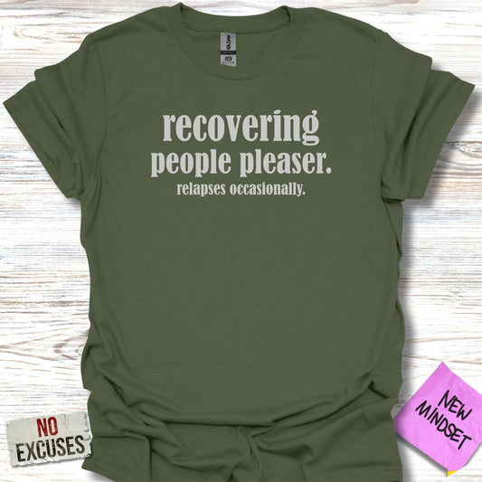 Olive green t-shirt with "RECOVERING people pleaser. relapses occasionally." text.