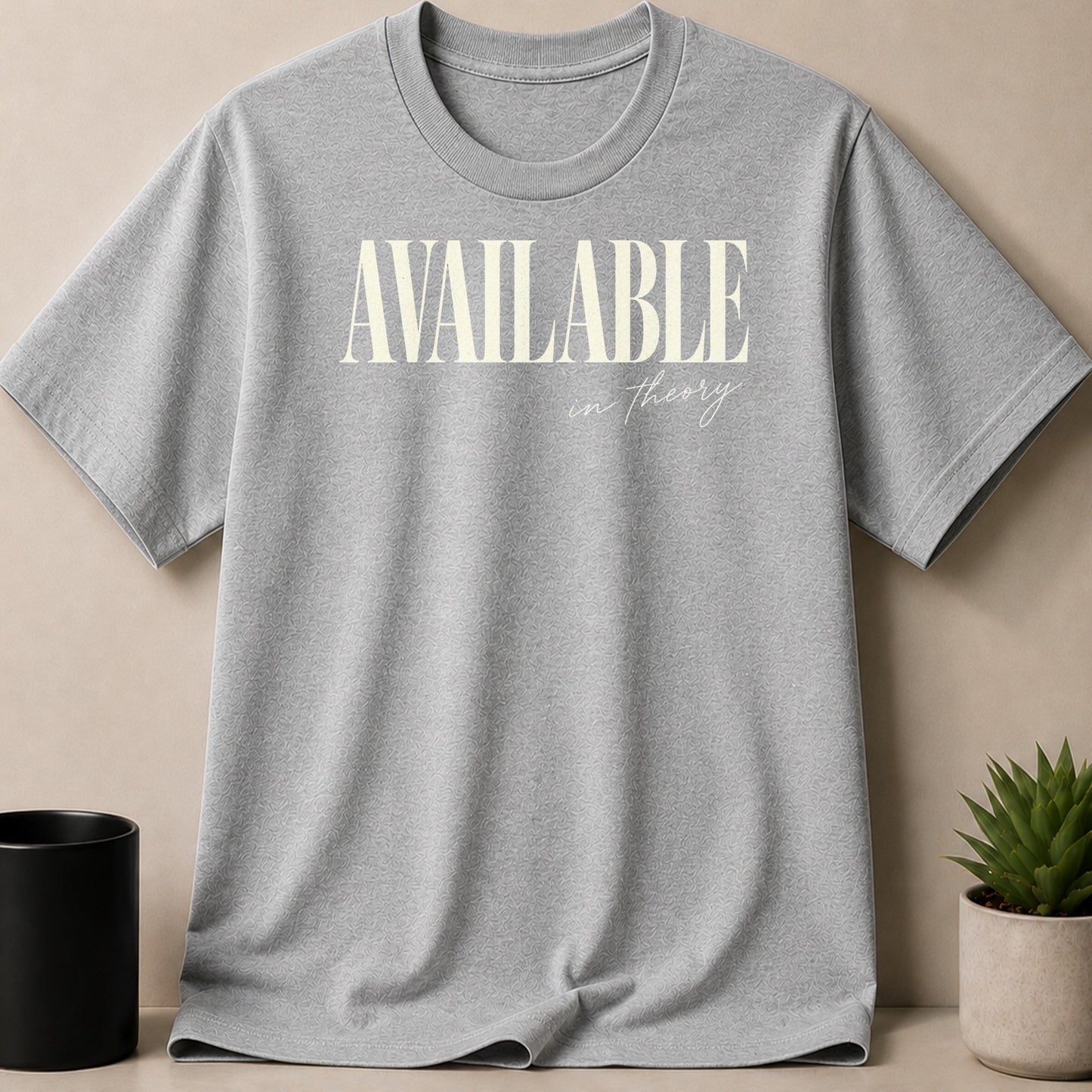 Grey t-shirt with "AVAILABLE in theory" text in cream.
