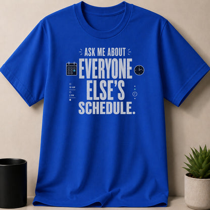 Blue t-shirt with text "ASK ME ABOUT EVERYONE ELSE'S SCHEDULE" and calendar/clock icons.