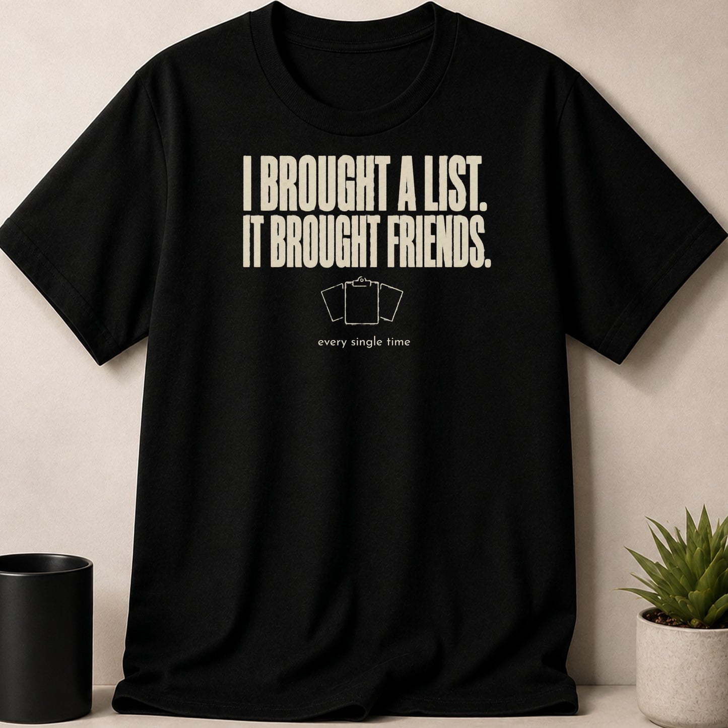 Black t-shirt with "I BROUGHT A LIST. IT BROUGHT FRIENDS." text and clipboard graphic.