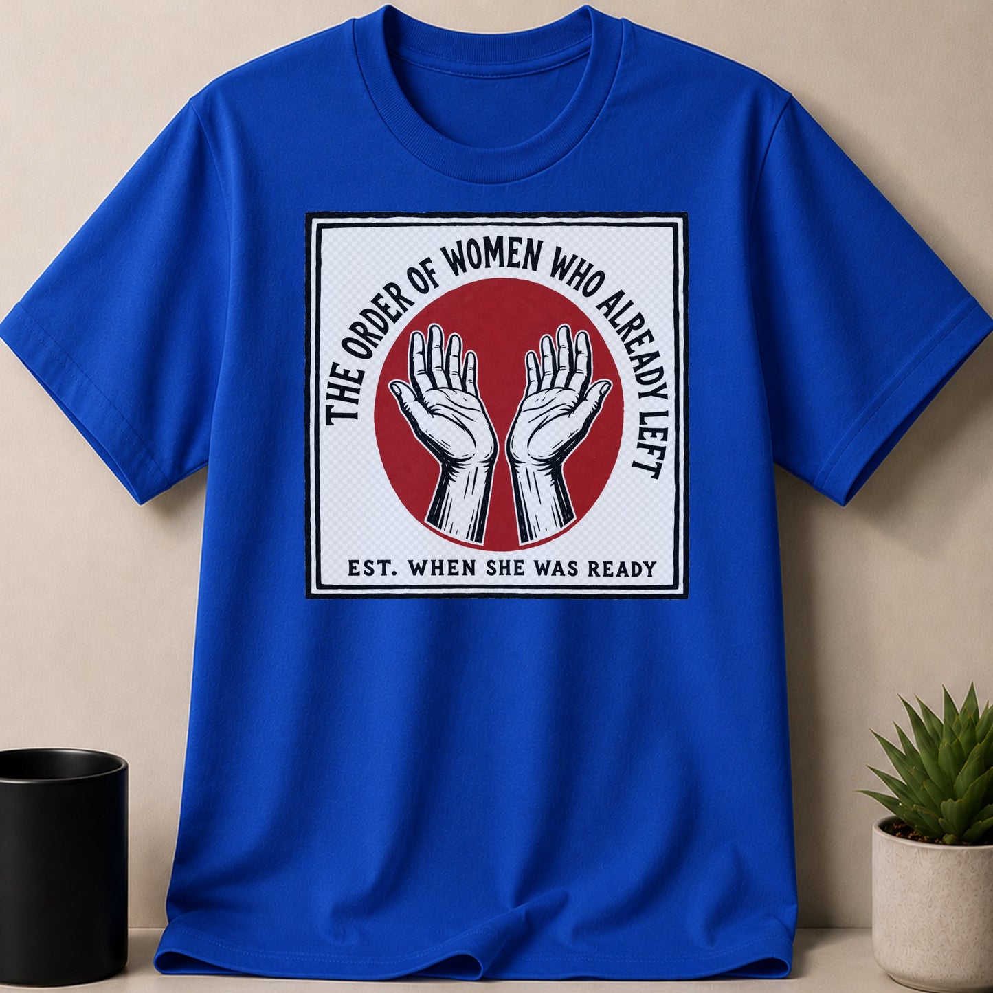 Blue t-shirt with "The Order of Women Who Already Left Est. When She Was Ready" graphic.
