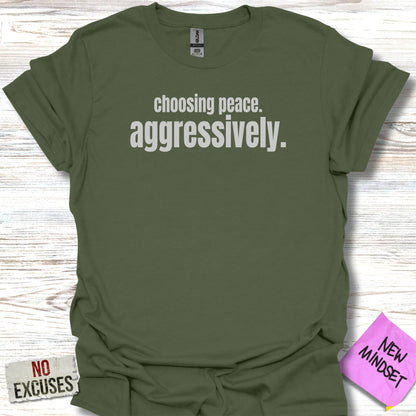 Green t-shirt with "choosing peace. aggressively." text.