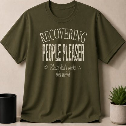 Olive green t-shirt with "Recovering People Pleaser. Please don't make this weird" text.