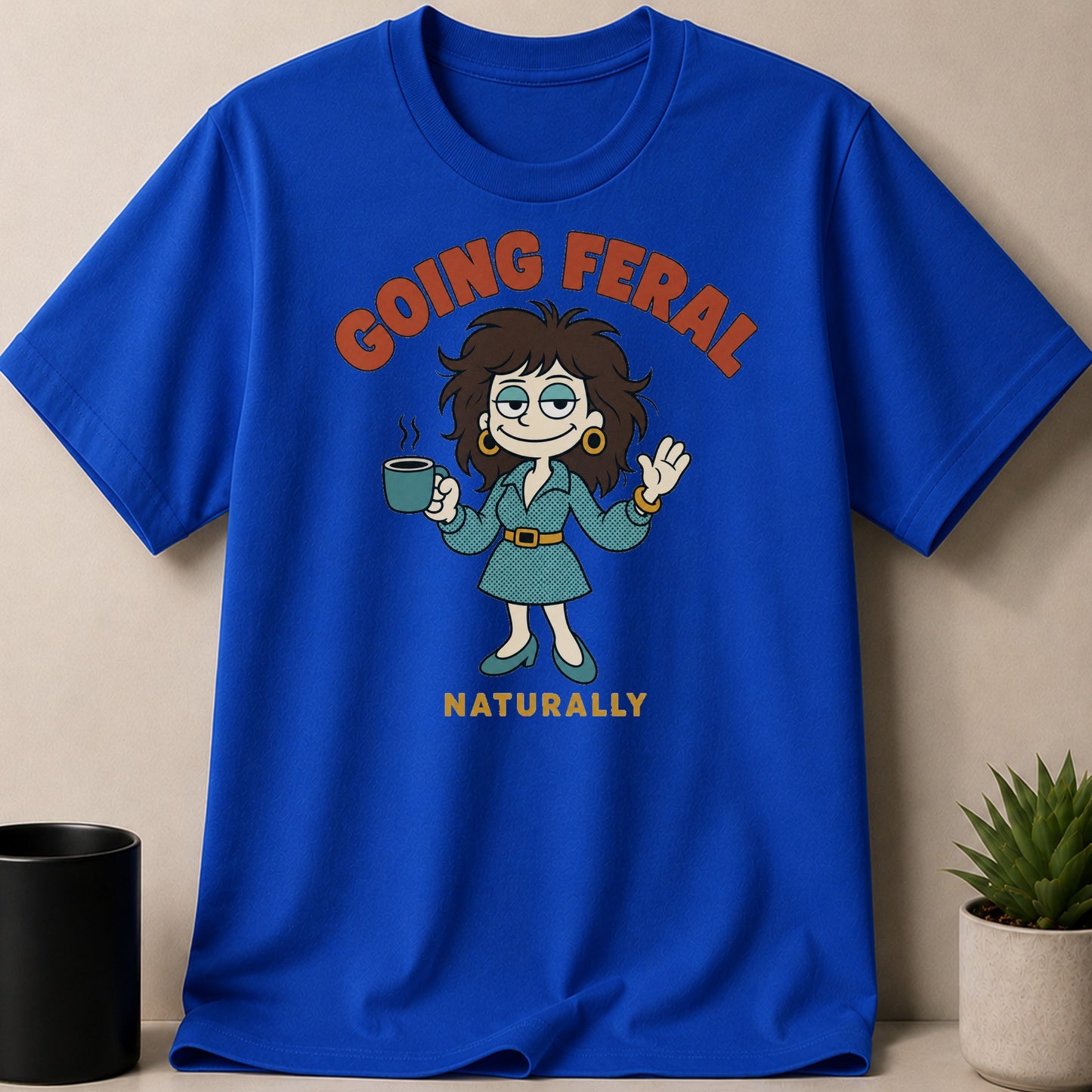 Blue t-shirt with "Going Feral Naturally" text and cartoon character holding coffee.