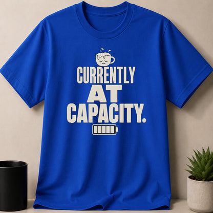 Blue t-shirt with "Currently at Capacity" and low battery graphic.