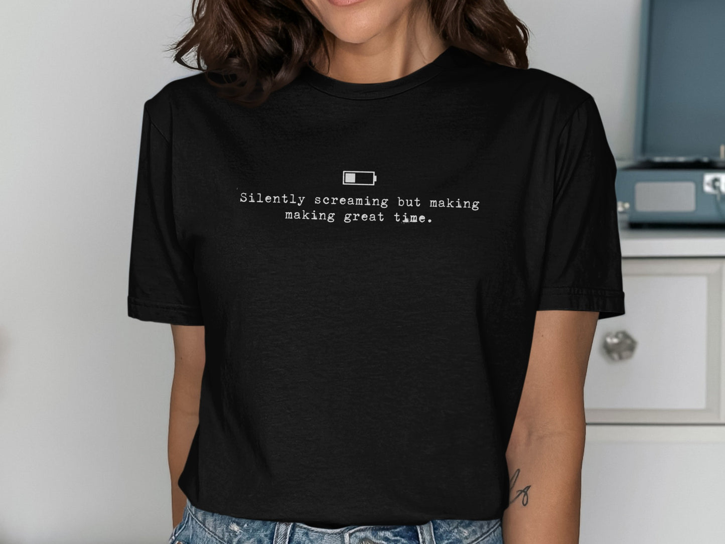 Black t-shirt with text "Silently screaming but making great time." and a low battery icon.