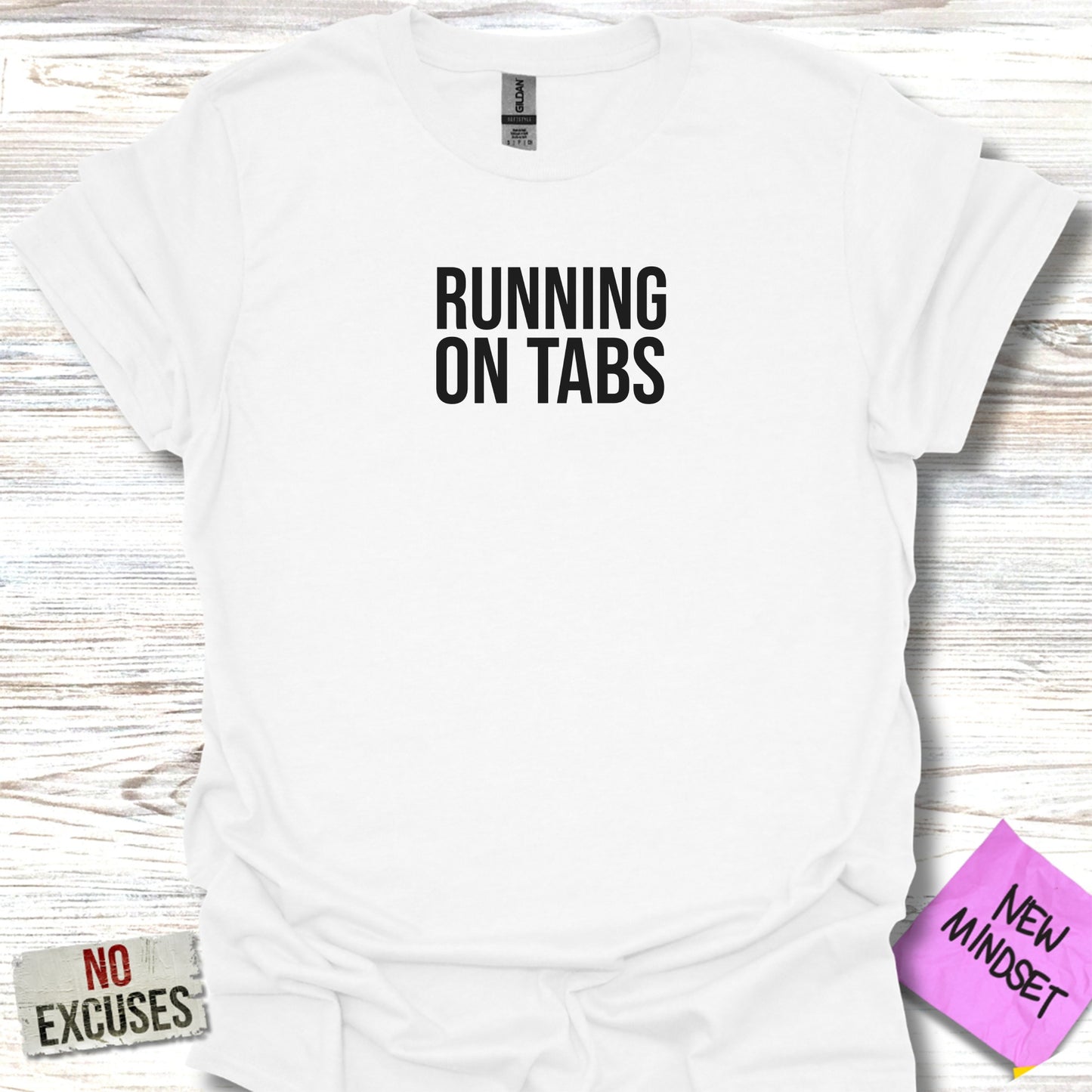White t-shirt with black text that says "RUNNING ON TABS" and "NO EXCUSES".