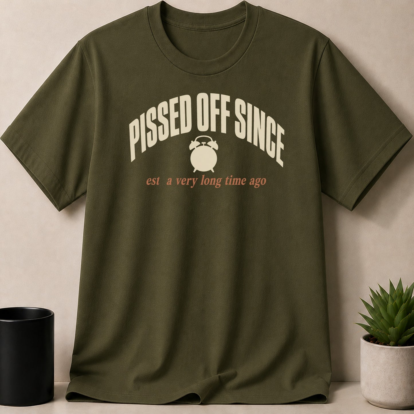Olive green t-shirt with "Pissed Off Since" and alarm clock graphic.