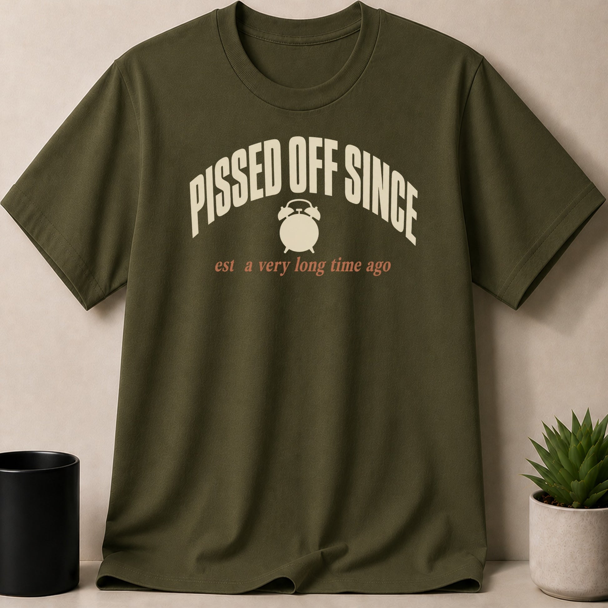Olive green t-shirt with "Pissed Off Since" and alarm clock graphic.