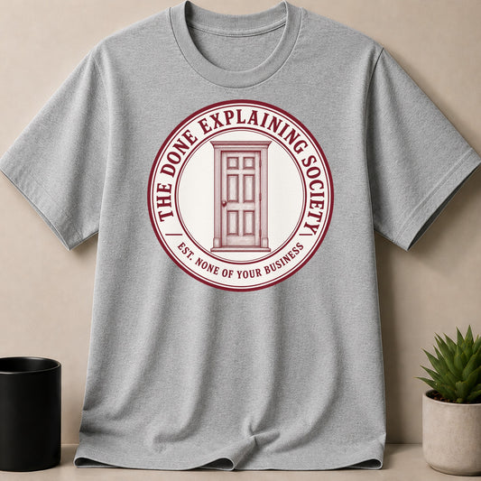 Grey t-shirt with a circular emblem featuring a door and text.
