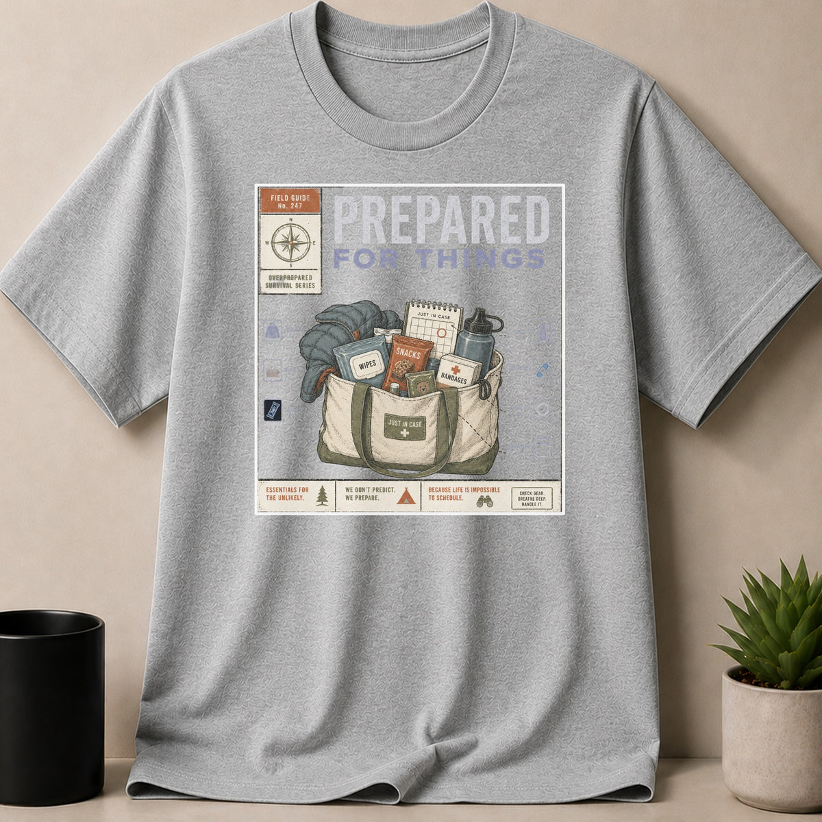 Grey t-shirt with "Prepared For Things" graphic featuring a bag of survival items.