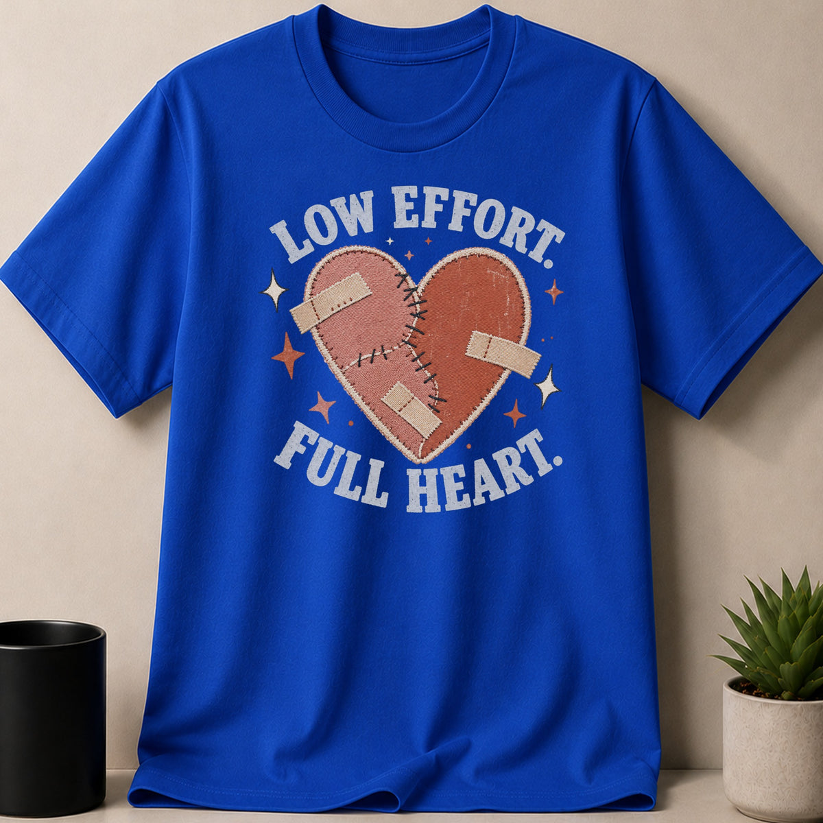 Blue t-shirt with stitched heart graphic and text "LOW EFFORT FULL HEART".