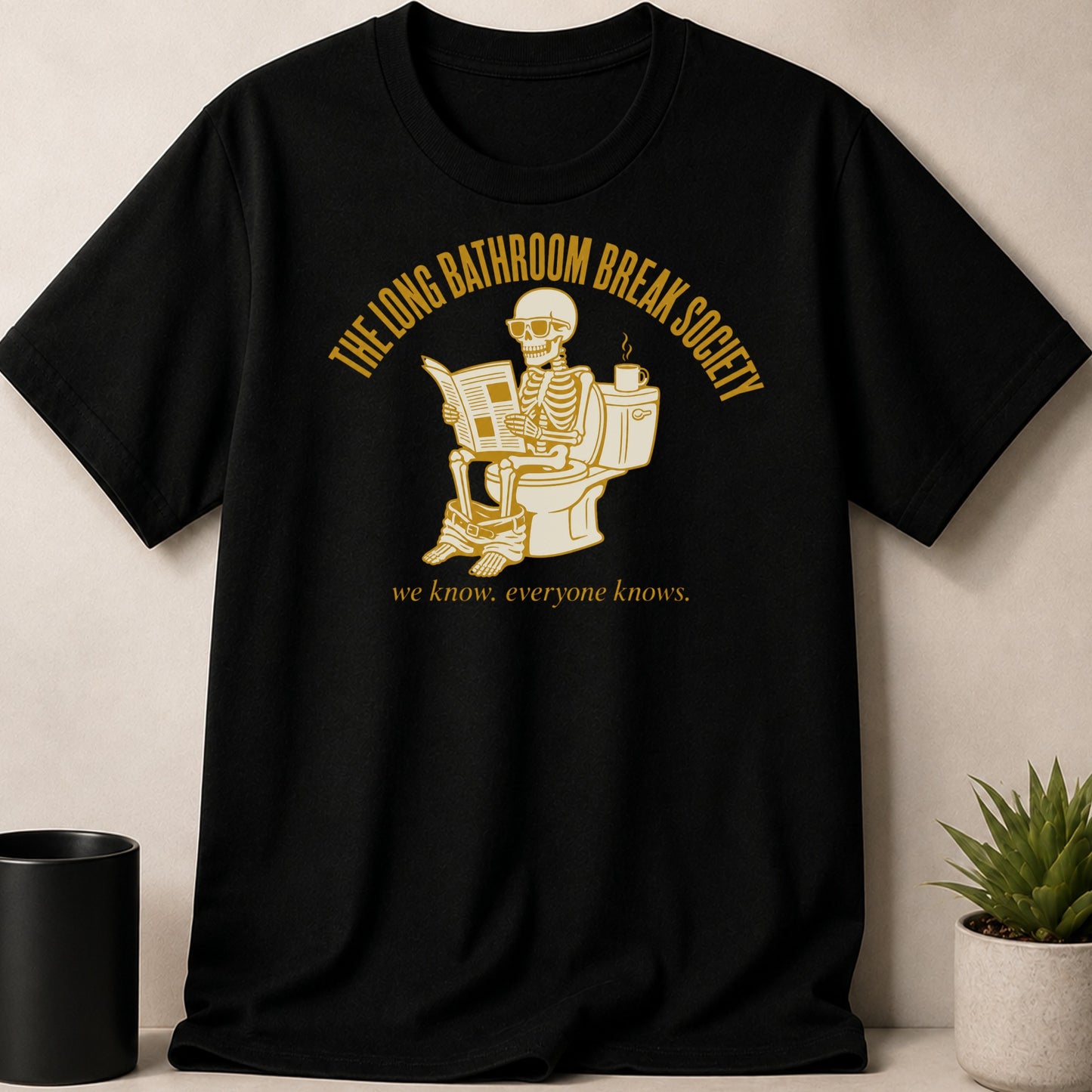 Black t-shirt with skeleton on toilet reading, "The Long Bathroom Break Society."