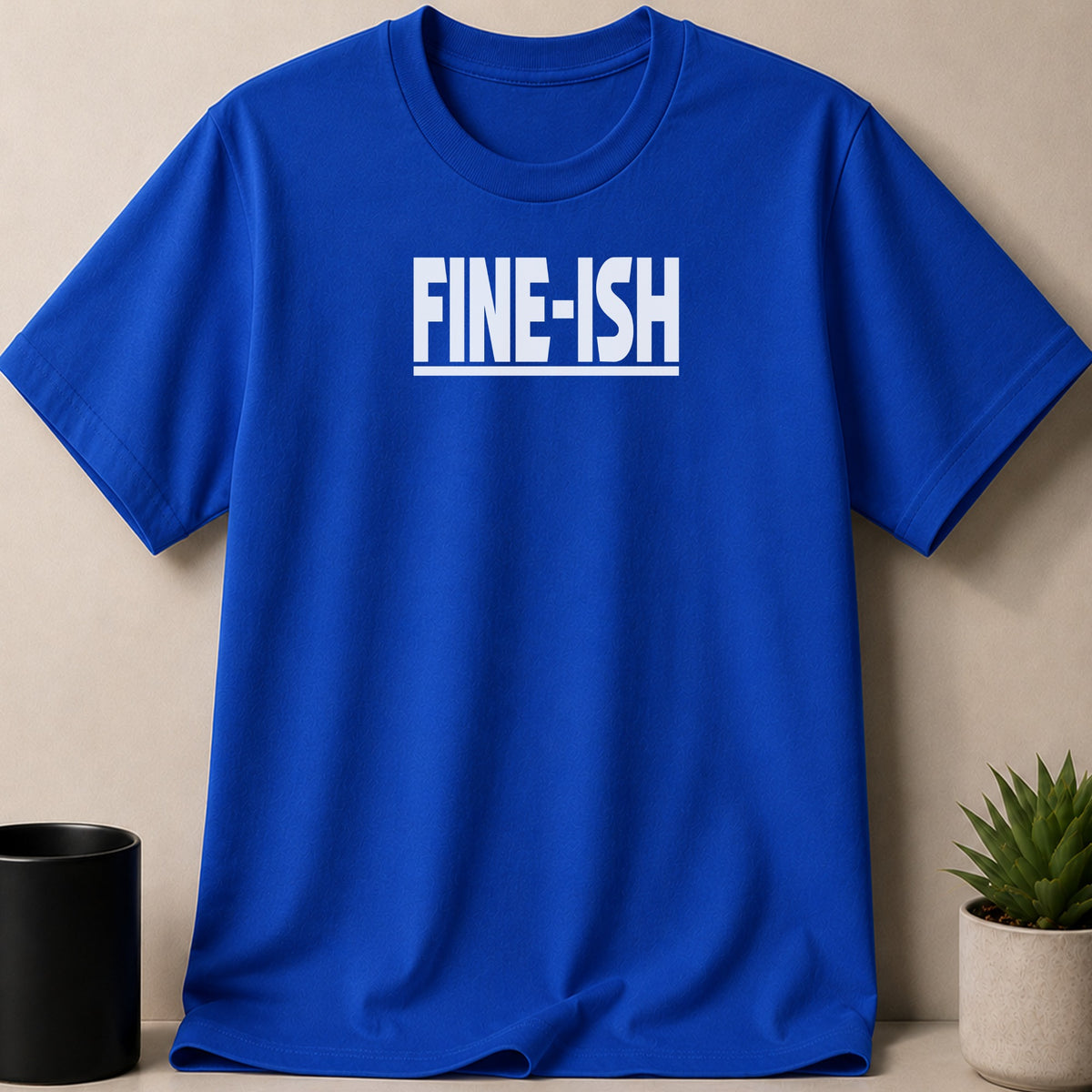 Royal blue t-shirt with white "FINE-ISH" text and a line underneath.
