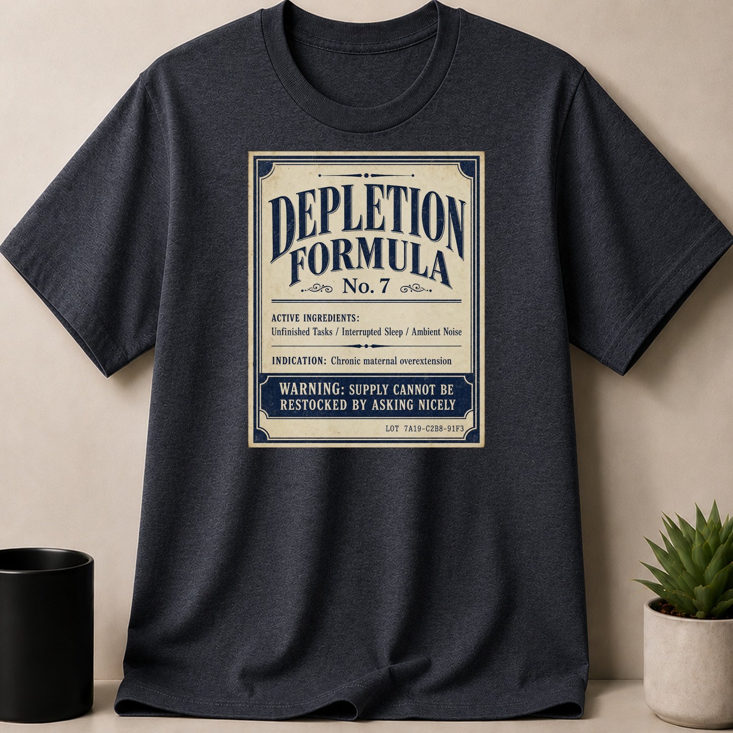 Dark grey t-shirt with "Depletion Formula No. 7" graphic and humorous ingredients.