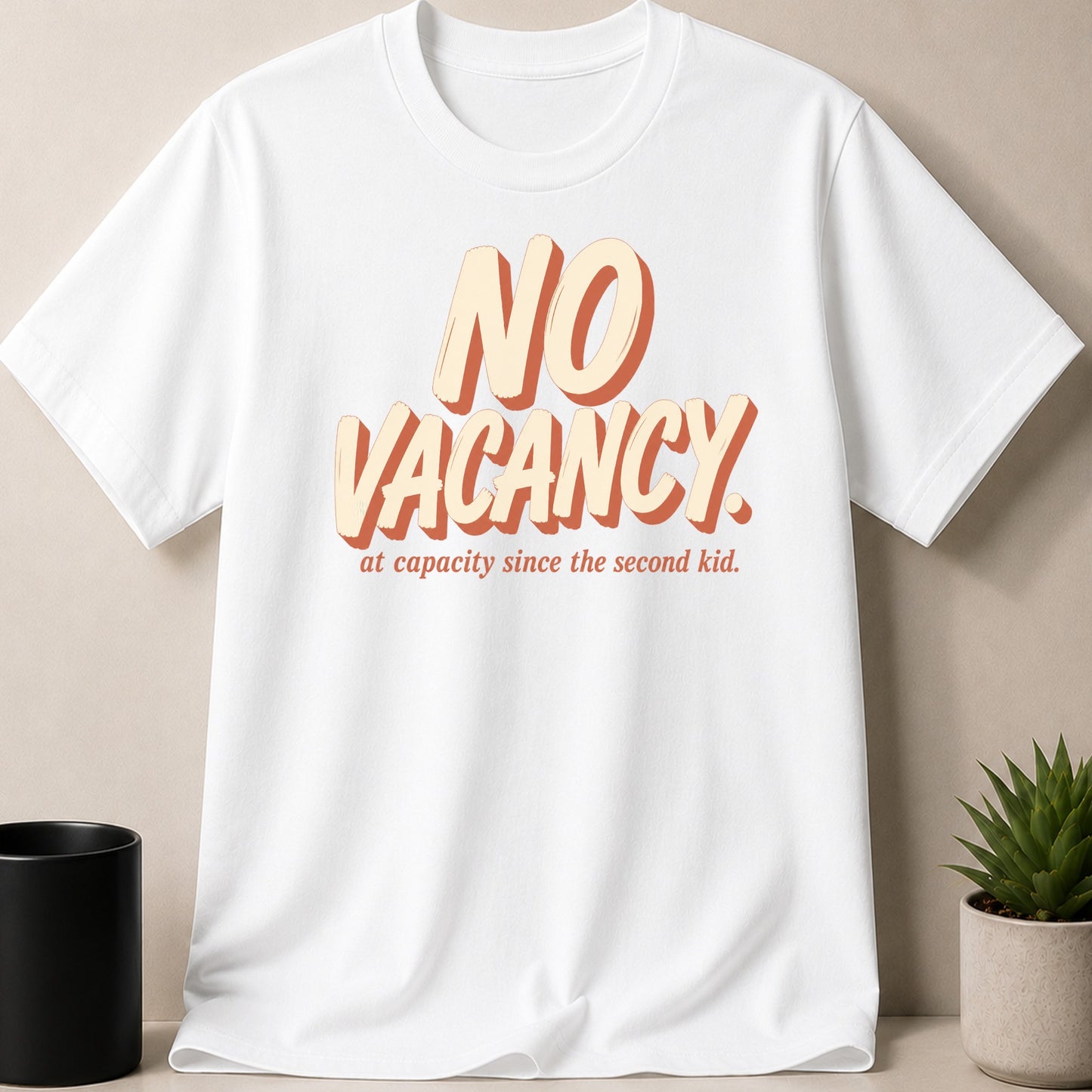 White t-shirt with "NO VACANCY. at capacity since the second kid." text.