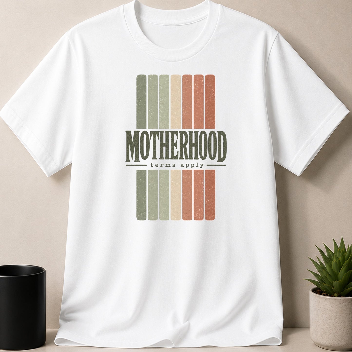 White t-shirt with distressed "Motherhood terms apply" text over vertical stripes.