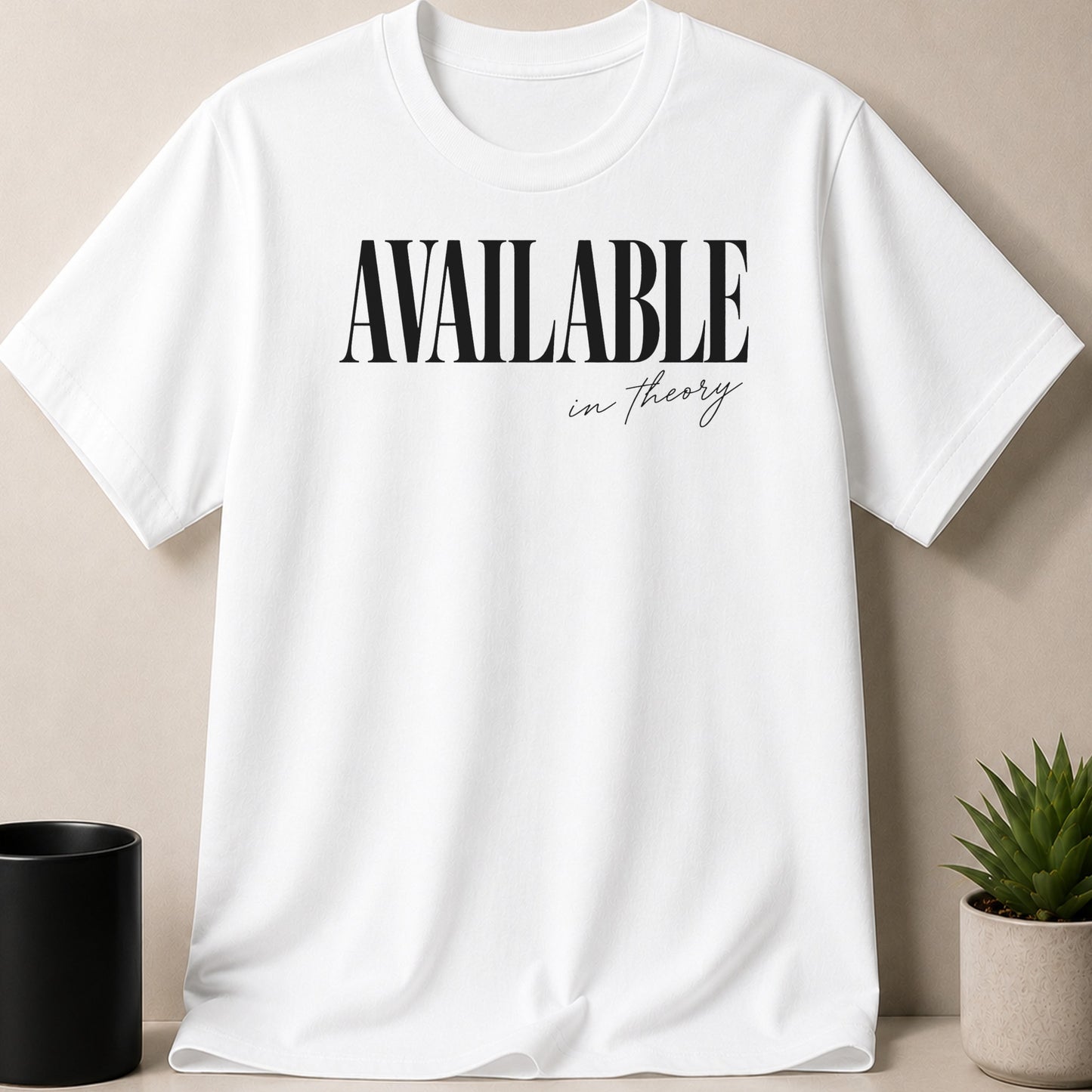 White t-shirt with "AVAILABLE in theory" text in black font.