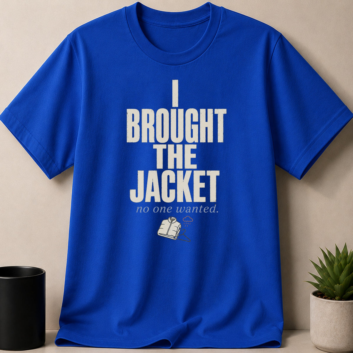 Blue t-shirt with text "I BROUGHT THE JACKET no one wanted" and jacket graphic.