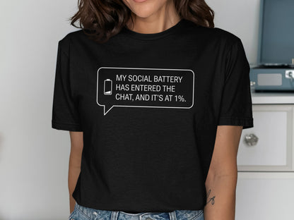 Black t-shirt with text bubble: "MY SOCIAL BATTERY HAS ENTERED THE CHAT, AND IT'S AT 1%."