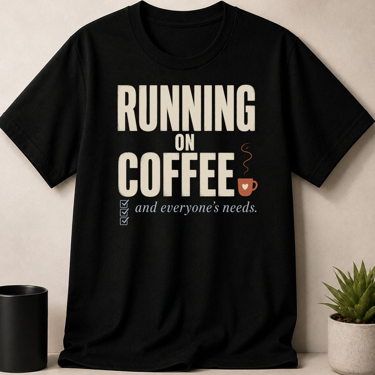 Black t-shirt with text "RUNNING ON COFFEE and everyone's needs."