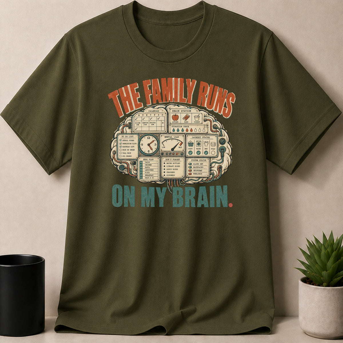Military Green t-shirt — T-shirt graphic with text "The family runs on my brain," showing a brain-shaped control panel.