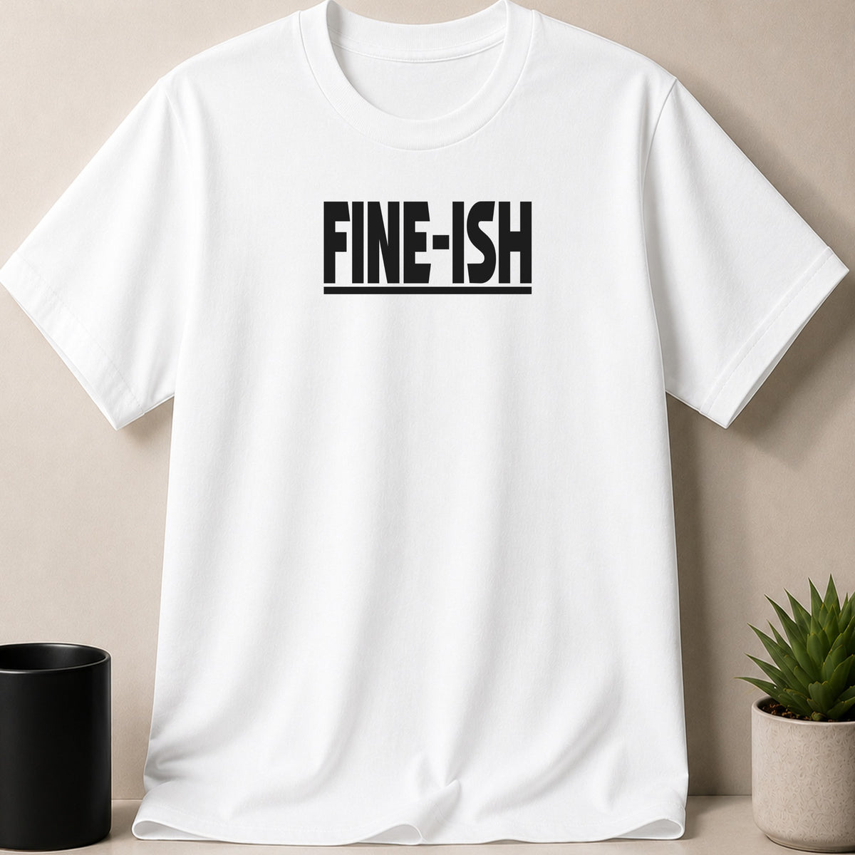 White t-shirt with "FINE-ISH" text printed on the chest.