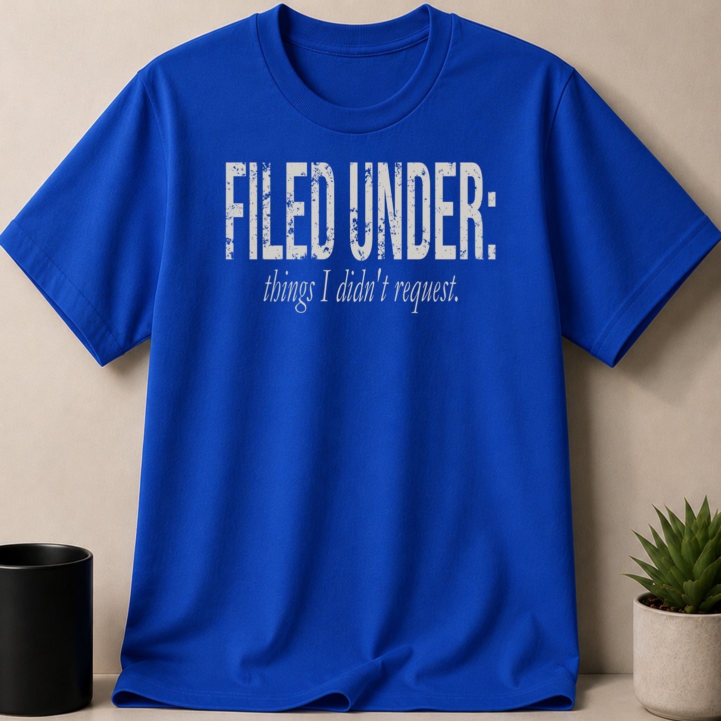 Royal blue t-shirt with distressed white text that reads "FILED UNDER: things I didn't request."