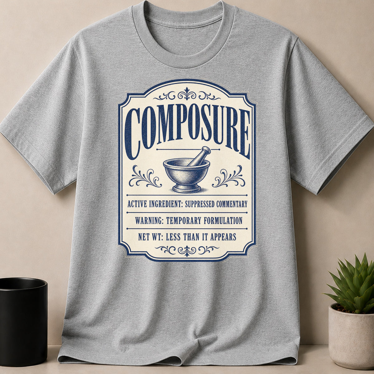 Gray t-shirt with "Composure" label featuring mortar and pestle and text.