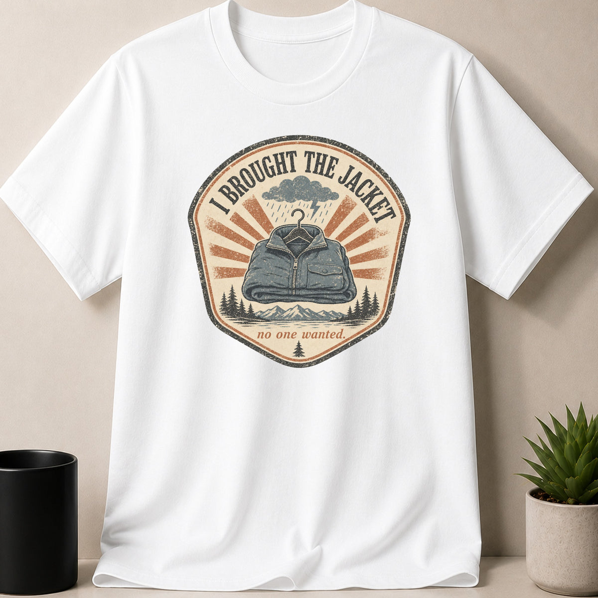 White t-shirt with a graphic showing a jacket and the text "I BROUGHT THE JACKET no one wanted."