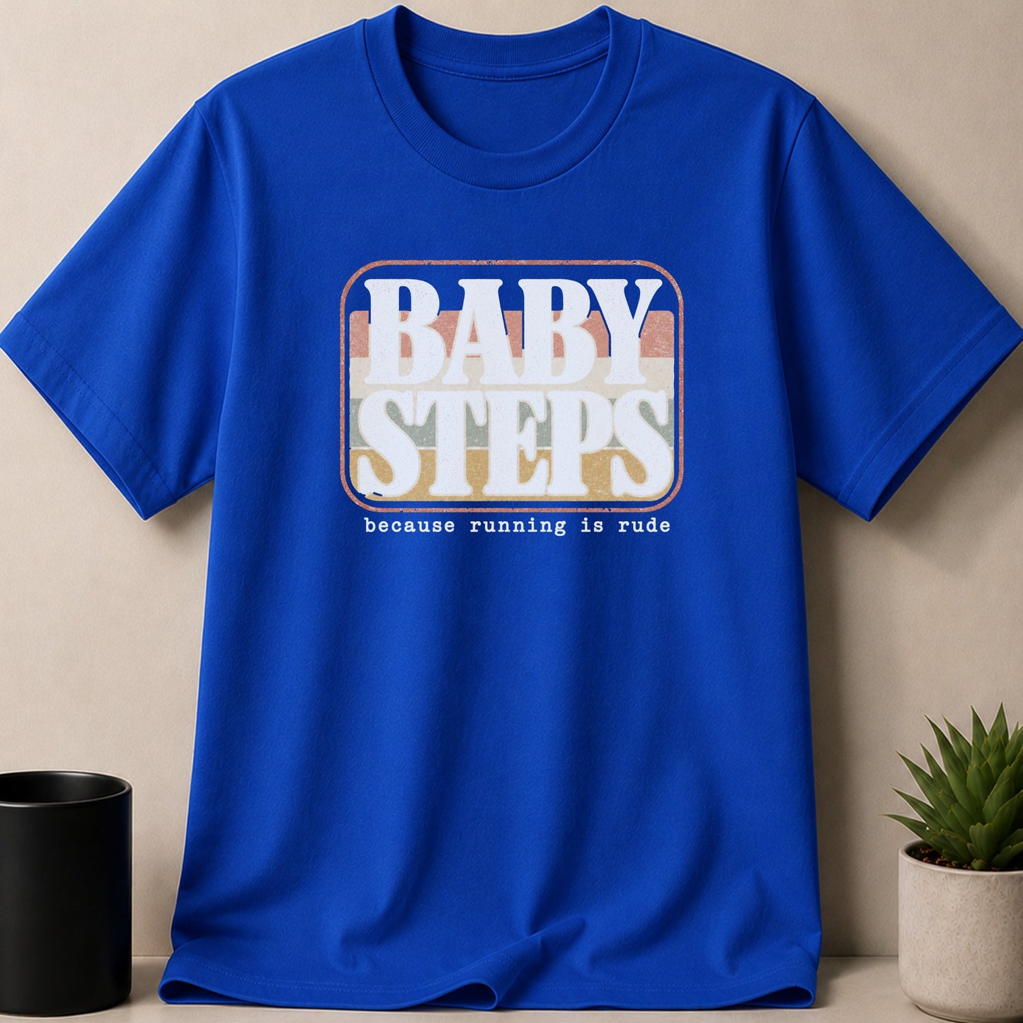 Blue t-shirt with white text "BABY STEPS because running is rude."