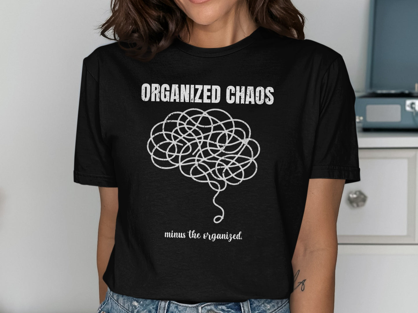 T-shirt with "ORGANIZED CHAOS" and tangled string brain graphic.