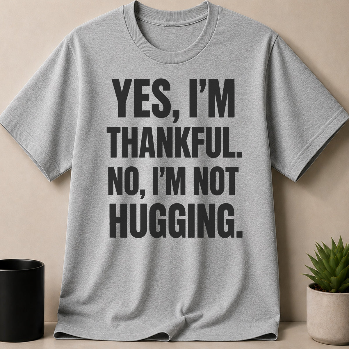 Grey t-shirt with black text "YES, I'M THANKFUL. NO, I'M NOT HUGGING."