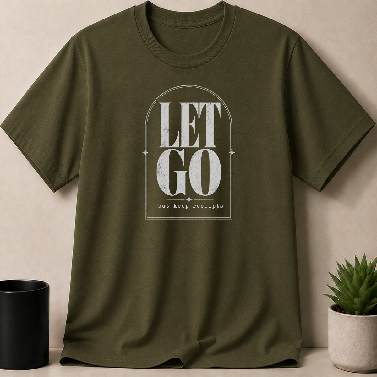Olive green t-shirt with distressed white text "LET GO but keep receipts".