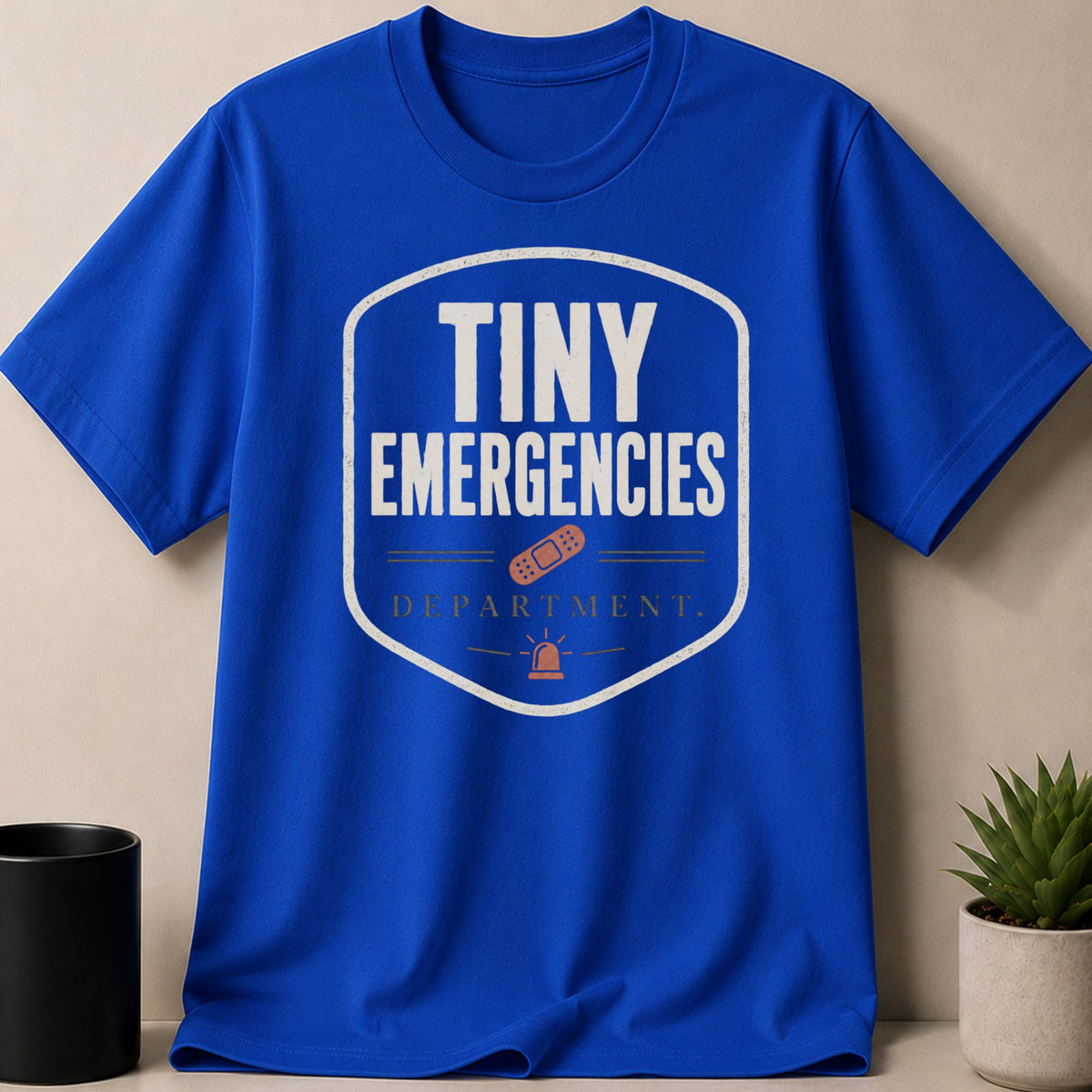 Royal blue t-shirt with "Tiny Emergencies Department" text and graphics.