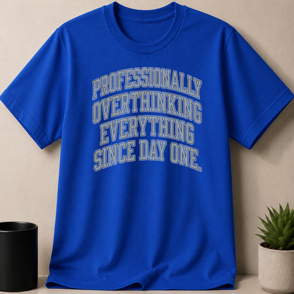 Blue t-shirt with "Professionally Overthinking Everything Since Day One" text.